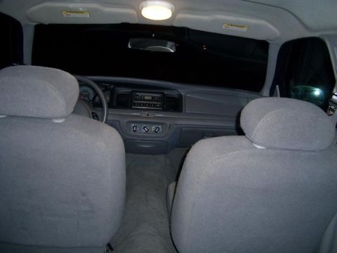 1999 Ford Crown Victoria - Interior view from the back seat, carpet not cleaned in a while, note small cut from equipment wiring