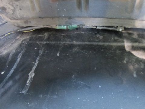 2001 Ford Crown Victoria - This image shows a close-up view of a vehicle's trunk area, focusing on a taped wiring harness.