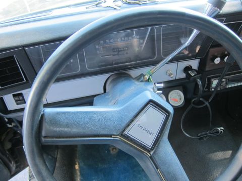 2001 Ford Crown Victoria - Interior view of a Chevrolet vehicle's dashboard and steering wheel.