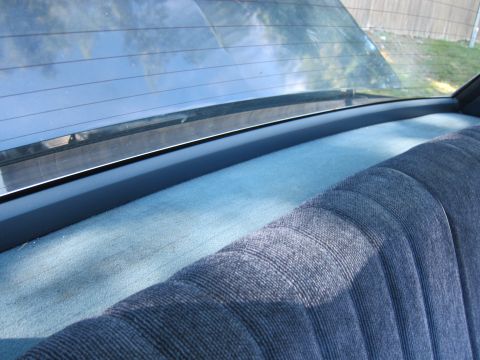 2001 Ford Crown Victoria - Close-up view of the rear seat upholstery and the interior of the rear window.