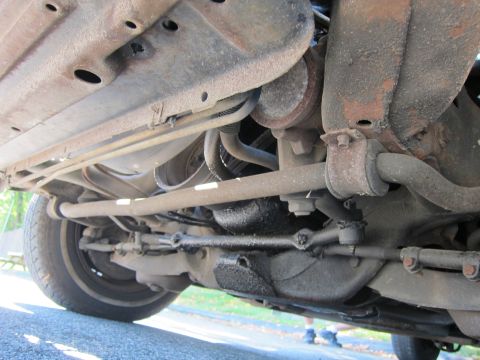 2001 Ford Crown Victoria - Undercarriage view of a vehicle's suspension and steering components.