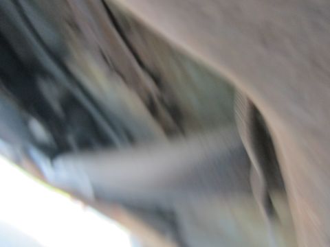 2001 Ford Crown Victoria - The blurry undercarriage of a vehicle is visible, with no clear identifying features.