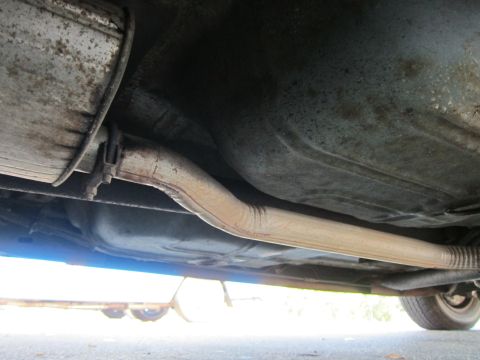 2001 Ford Crown Victoria - Underside view of a vehicle's exhaust system, showing the pipe and muffler.