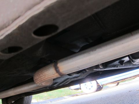 2001 Ford Crown Victoria - The undercarriage of a vehicle, focusing on the exhaust system and frame components.