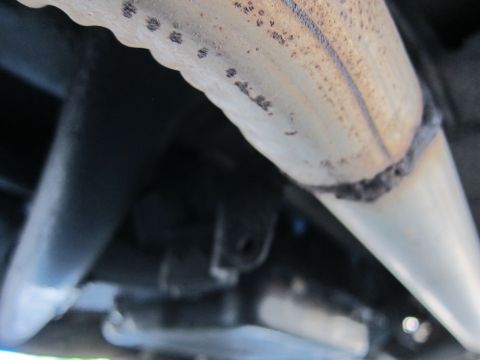 2001 Ford Crown Victoria - Underside view of a vehicle's exhaust system and chassis components.