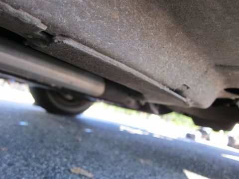 2001 Ford Crown Victoria - Photo of a vehicle undercarriage and exhaust, not a technical document.