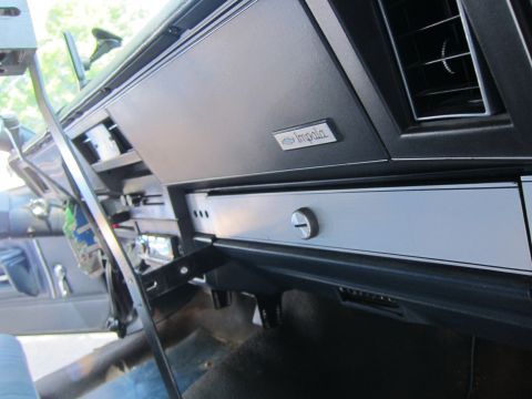 2001 Ford Crown Victoria - Close-up of a car's dashboard, showing the 'Impala' emblem and a vent.