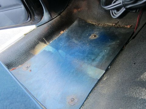 2001 Ford Crown Victoria - The interior of a vehicle is visible, showing a dashboard area with a blue hue.