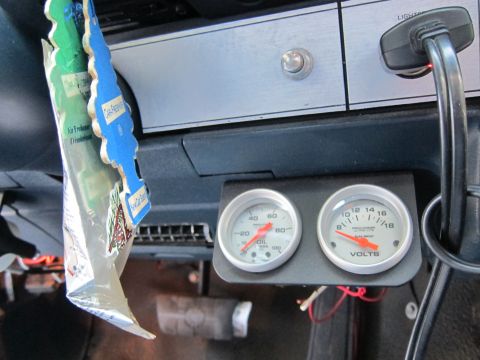 2001 Ford Crown Victoria - Interior view of a vehicle's dashboard aftermarket gauges and air fresheners.
