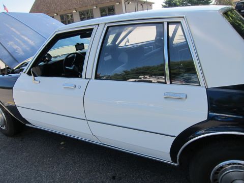 2001 Ford Crown Victoria - Photograph of a classic four-door sedan's side, not a technical document.