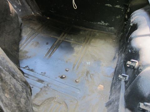 2001 Ford Crown Victoria - Photograph of a car trunk floor pan, not a technical document.