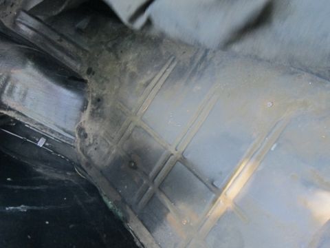2001 Ford Crown Victoria - Photograph of a car trunk floor pan, not a technical document.