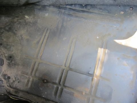 2001 Ford Crown Victoria - Photograph of a car trunk floor, not a technical document.