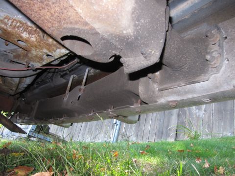2001 Ford Crown Victoria - Photograph of a car's rusty underbody, not a technical document.