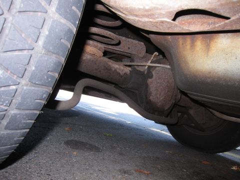 2001 Ford Crown Victoria - Underside view of a vehicle, focusing on the tire and exhaust system.