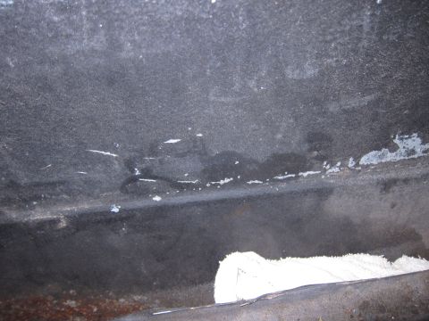 2001 Ford Crown Victoria - Close-up view of the undercarriage, showing wear and some repair material.