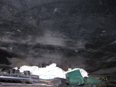 2001 Ford Crown Victoria - Close-up of a wiring harness and some white material tucked away beneath a dark, textured surface.