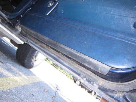 2001 Ford Crown Victoria - Photograph of a car door and sill, not a technical document.