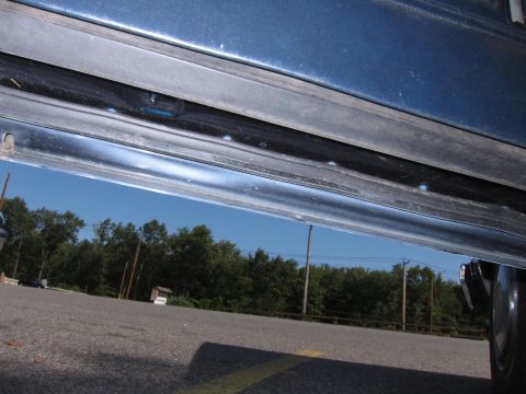2001 Ford Crown Victoria - Photograph of a car rocker panel, not a technical document.