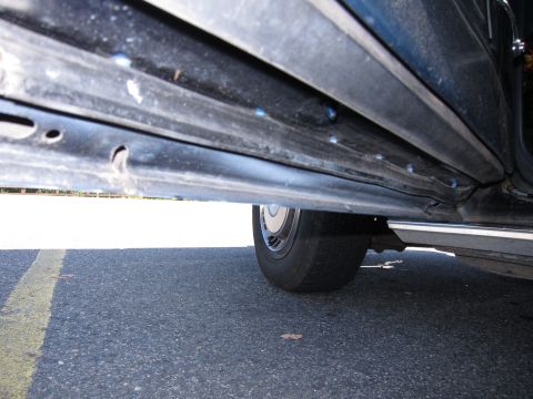 2001 Ford Crown Victoria - Photograph of a car rocker panel, not a technical document.