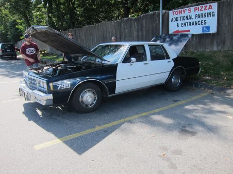 2001 Ford Crown Victoria - Photograph of a classic police sedan, not a technical document.