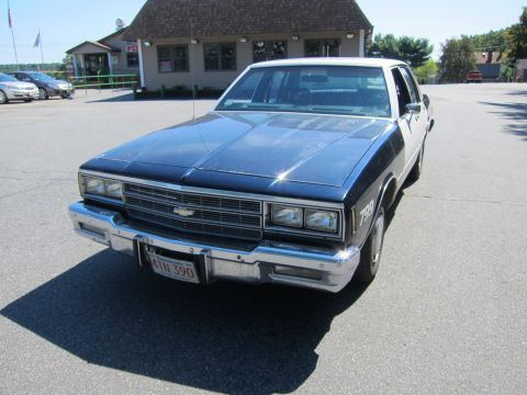 2001 Ford Crown Victoria - This Chevrolet Caprice has a two-tone paint scheme and a prominent chrome grille.