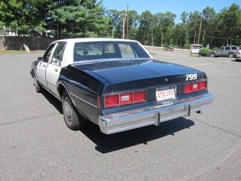 2001 Ford Crown Victoria - This police car, marked with "799" and a Massachusetts license plate, is viewed from the rear.
