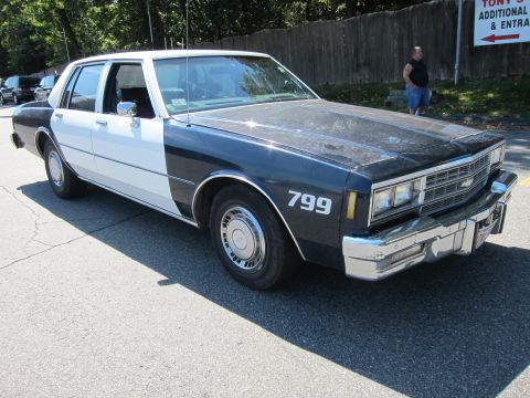 2001 Ford Crown Victoria - This police car has a two-tone paint scheme and the number 799 displayed on its side.