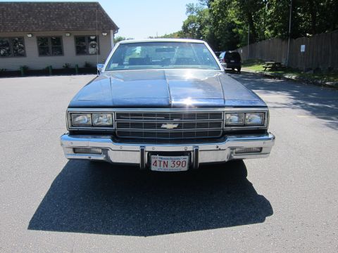 2001 Ford Crown Victoria - This Chevrolet Caprice sedan displays a classic front-end design with its prominent chrome grille and rectangular headlights.
