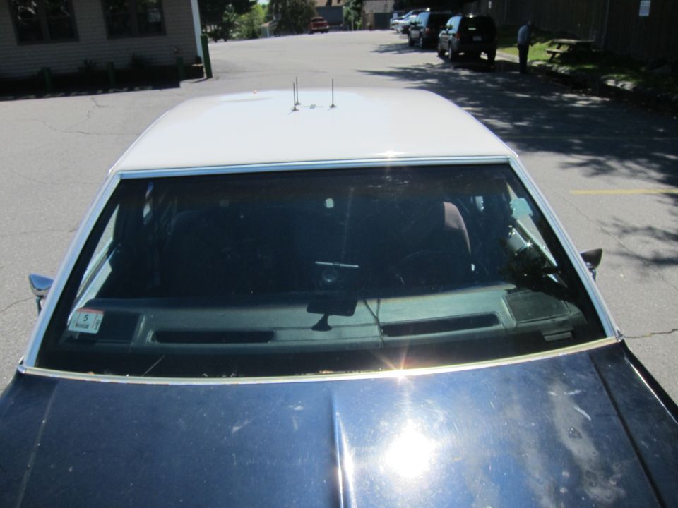 2001 Ford Crown Victoria police car interior, dashboard, and roof with dual antennas