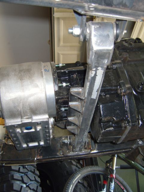 1985 Jeep CJ7 - Underside view of a vehicle's drivetrain and suspension components, with a bicycle wheel visible below.