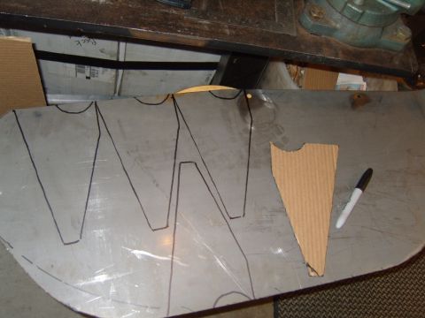 1985 Jeep CJ7 - A metal sheet is marked with template lines, alongside a cardboard cutout and a black marker.