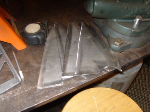 1985 Jeep CJ7 - Several cut metal pieces are visible on a workbench, alongside tools and a vise.