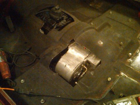 1985 Jeep CJ7 - Floor pan modifications with cutouts for drivetrain components and exhaust system.