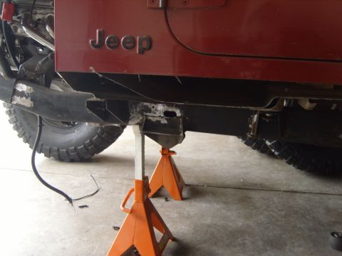 1985 Jeep CJ7 - The Jeep's frame is being worked on while it's supported by orange jack stands.