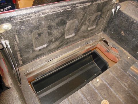 1985 Jeep CJ7 - This image shows the under-seat storage compartment of a vehicle, not a 1985 Jeep CJ7.