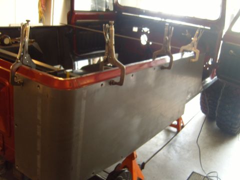 1985 Jeep CJ7 - A Jeep CJ's side panel is being repaired with clamps holding the new metal in place.
