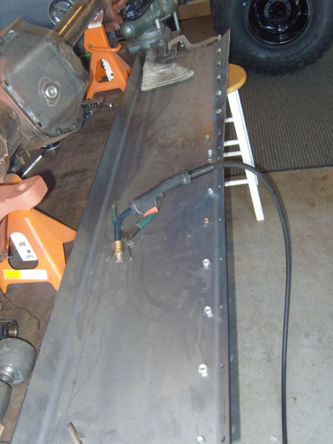 1985 Jeep CJ7 - A metal panel is prepared for welding, with tools and a tire visible in the garage setting.