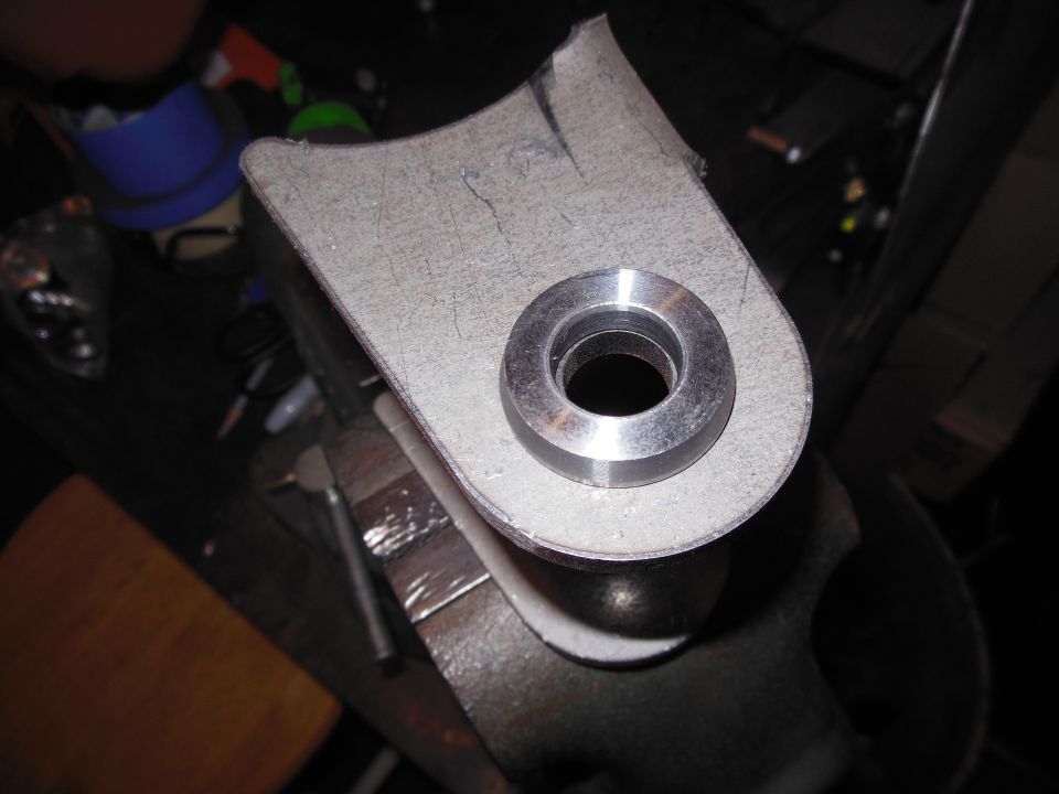 metal bracket with a metal bushing in a vise