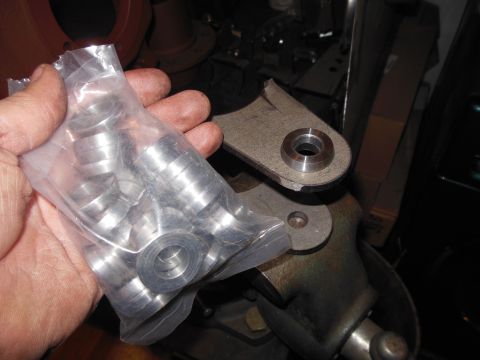 1985 Jeep CJ7 - A hand holds a plastic bag filled with metal washers near a metal bracket.