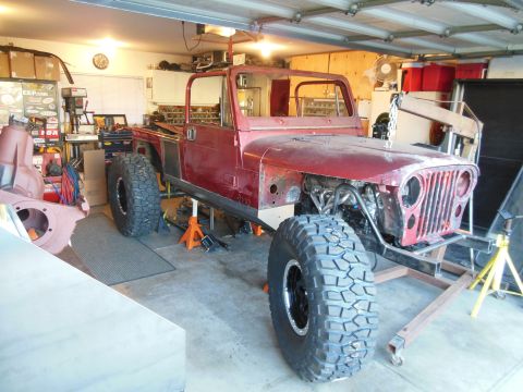 1985 Jeep CJ7 - This 1985 Jeep CJ7 is in a garage, appearing to be in the middle of a build or restoration project.