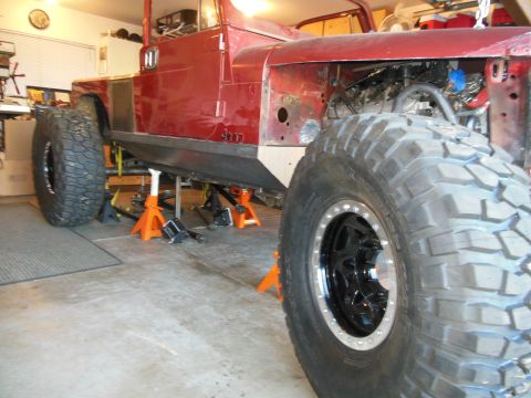 1985 Jeep CJ7 - This Jeep is undergoing modifications, with its front fender removed and large tires installed.