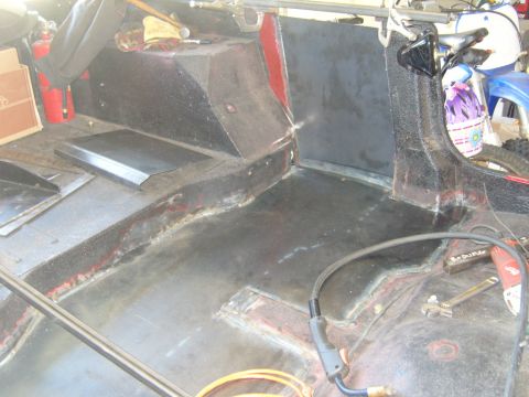 1985 Jeep CJ7 - The interior of a Jeep shows metal work and tools, indicating ongoing restoration or modification.
