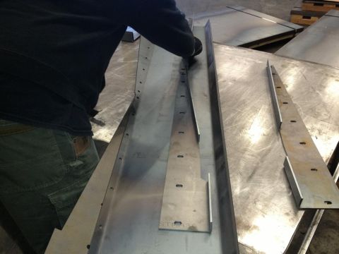 1985 Jeep CJ7 - Metal fabrication in progress on a workbench with multiple pieces.