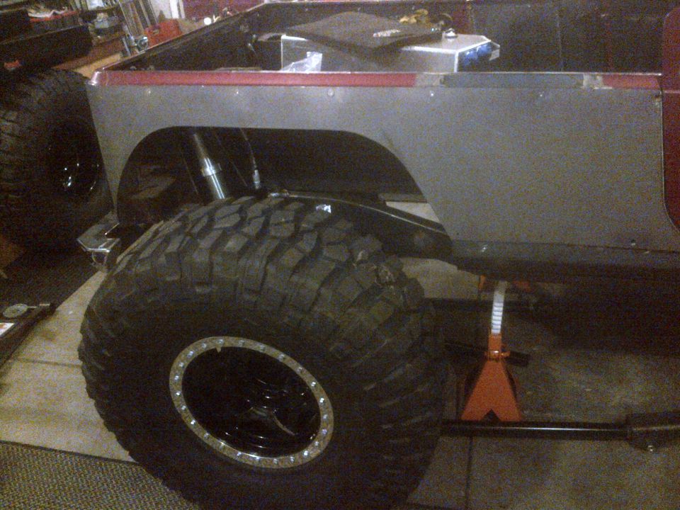 Jeep CJ body on jack stands with large off-road tires