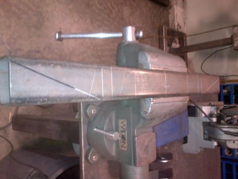 1985 Jeep CJ7 - A metal bar is secured in a vise, ready for modification or fabrication.