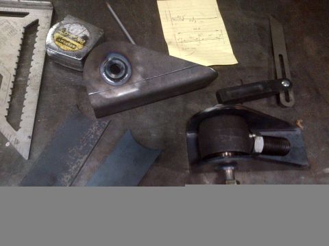 1985 Jeep CJ7 - Tools and metal components are laid out on a workbench, suggesting a fabrication project.