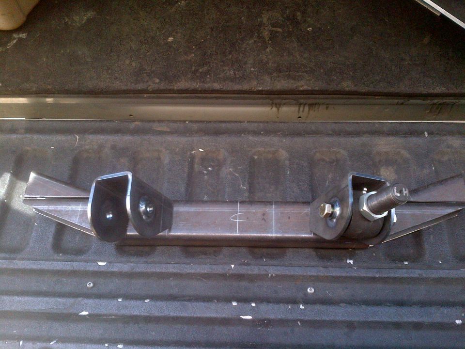 Custom fabricated suspension component with two mounting brackets and a threaded shaft marked 'LH'