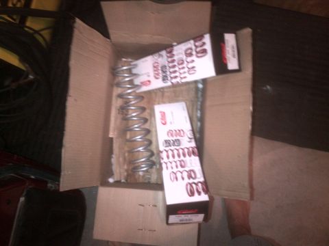 1985 Jeep CJ7 - New suspension springs are shown inside a cardboard box, ready for installation.
