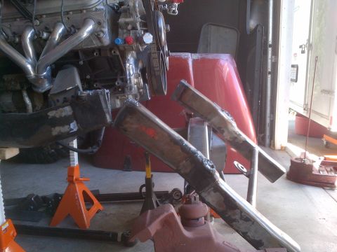 1985 Jeep CJ7 - Engine and frame components are supported by jack stands in a workshop setting.
